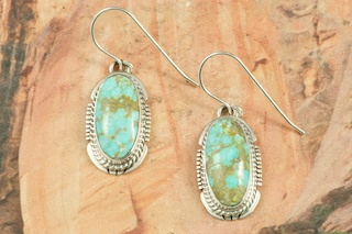 Genuine Number 8 Mine Turquoise Stones set in Sterling Silver French Wire Earrings. The Number 8 mine is located in Eureka County Nevada. Since 1976 there has been no Number 8 Turquoise mined. There is however, an existing stock pile that Mr. Dowell Ward, the last owner of the Number 8 mine, had stocked away for later sorting. The Turquoise is a collector's item--because once the reserve is gone there will be no more material released onto the market. The Gold Mining Company owns the claim to the Number 8 mine and it has been swallowed up by the gold mining operations. This is some of the last Number 8 Turquoise to be had and will be a great addition to your collection. Created by Navajo Artist Arkie Nelson. Signed by the artist.